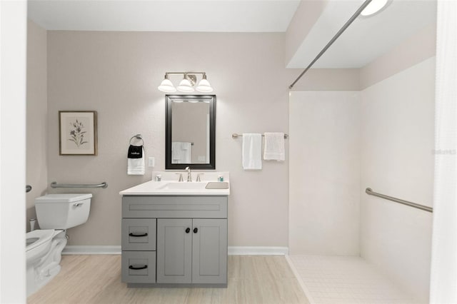 8024 Cool Breeze Dr Unit 132, Orlando, FL 32819 - bathroom featuring a shower, vanity, toilet, baseboards, and wood finished floors