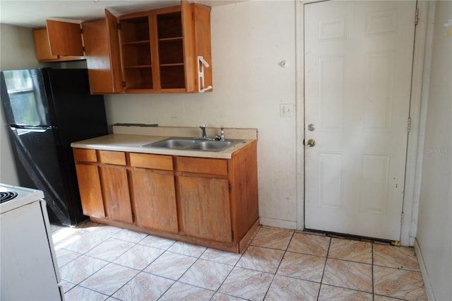 622 Booker, Lake Wales, FL 33853 - kitchen featuring a sink, light countertops, brown cabinets, and freestanding refrigerator