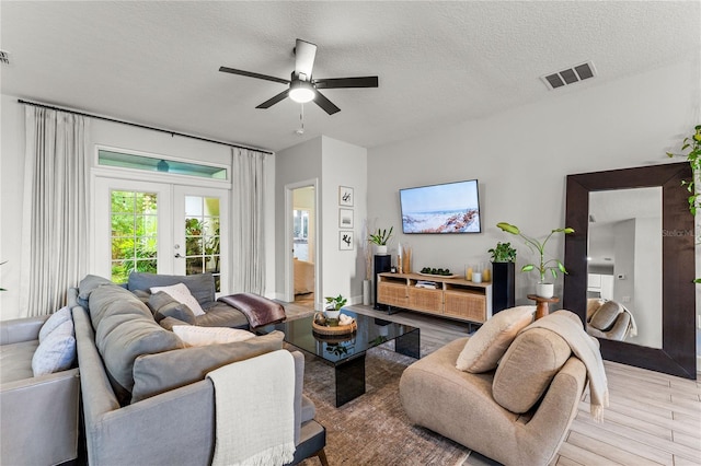 489 Grape Ave, Saint Cloud, FL 34769 - living room featuring light wood-style flooring, a ceiling fan, french doors, and a textured ceiling