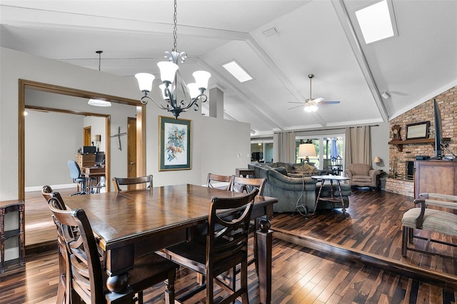 526 Sabal Trail Cir, Longwood, FL 32779 - dining area with wood-type flooring, lofted ceiling, a ceiling fan, a brick fireplace, and a chandelier