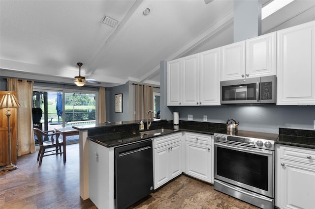 526 Sabal Trail Cir, Longwood, FL 32779 - kitchen with appliances with stainless steel finishes, a peninsula, ceiling fan, white cabinetry, and vaulted ceiling