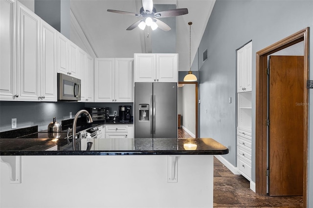 526 Sabal Trail Cir, Longwood, FL 32779 - kitchen with stainless steel fridge, a peninsula, lofted ceiling, a ceiling fan, and dark wood-style flooring