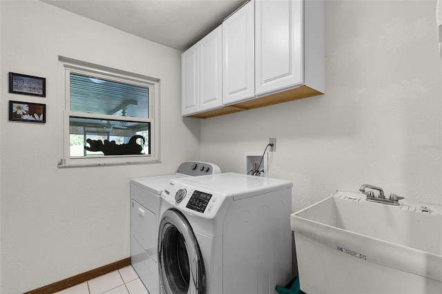526 Sabal Trail Cir, Longwood, FL 32779 - laundry area with washing machine and dryer, cabinet space, light tile patterned floors, and a textured ceiling