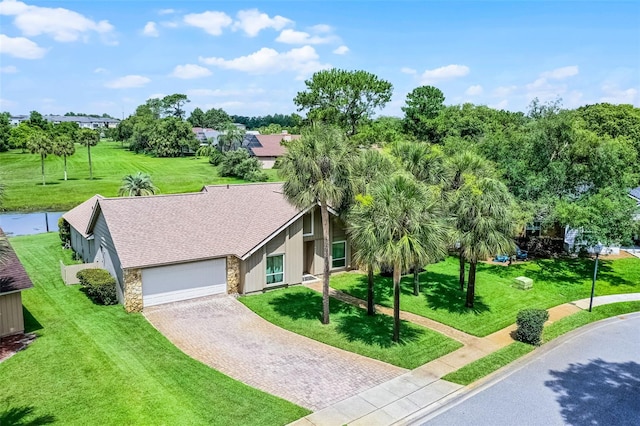 526 Sabal Trail Cir, Longwood, FL 32779 - mid-century home with stone siding, driveway, a garage, a shingled roof, and a front lawn
