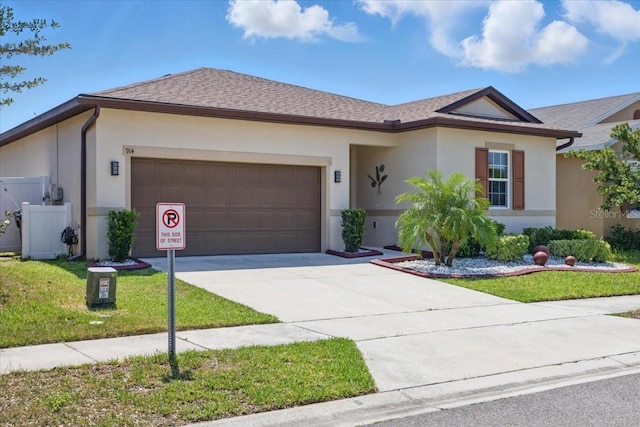 914 Fallon Hills Dr, Haines City, FL 33844 - ranch-style house with stucco siding, an attached garage, concrete driveway, and a front lawn