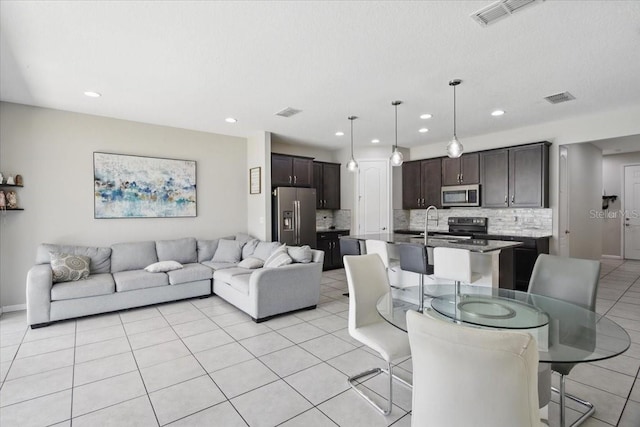 914 Fallon Hills Dr, Haines City, FL 33844 - living room with light tile patterned flooring and recessed lighting