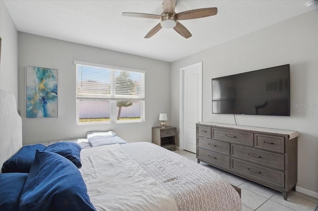 914 Fallon Hills Dr, Haines City, FL 33844 - bedroom with light tile patterned floors, baseboards, and a ceiling fan