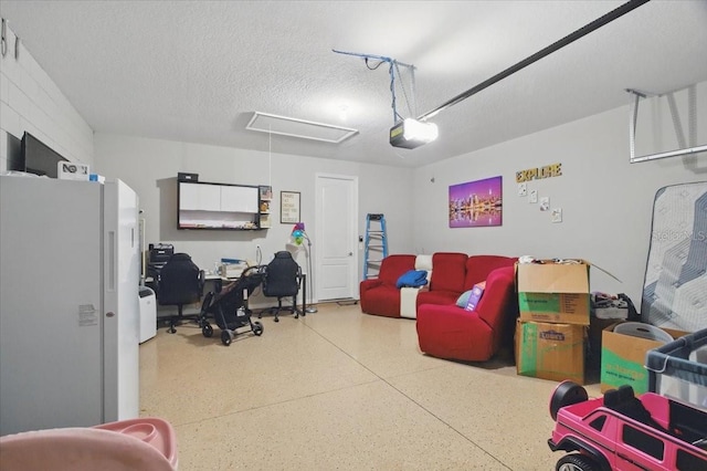 914 Fallon Hills Dr, Haines City, FL 33844 - garage featuring freestanding refrigerator and a garage door opener
