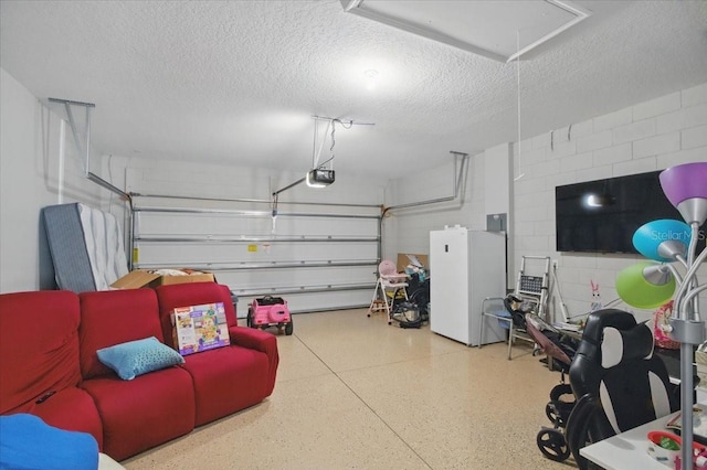 914 Fallon Hills Dr, Haines City, FL 33844 - garage with concrete block wall, a garage door opener, and freestanding refrigerator