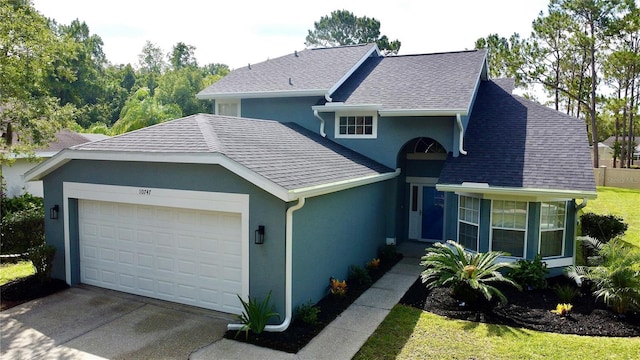 10747 Satinwood Cir, Orlando, FL 32825 - view of front of home with an attached garage, stucco siding, and driveway