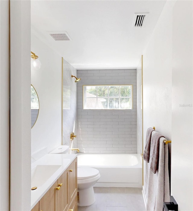 10747 Satinwood Cir, Orlando, FL 32825 - full bathroom featuring toilet, vanity, tile patterned flooring, and shower / bath combination