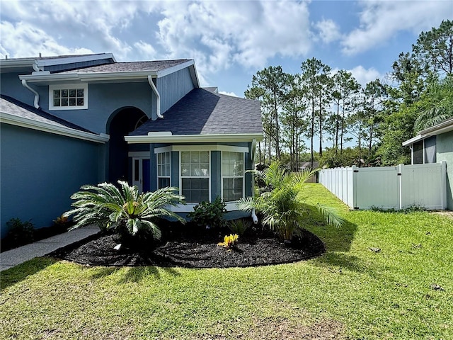 10747 Satinwood Cir, Orlando, FL 32825 - view of side of property featuring roof with shingles and stucco siding