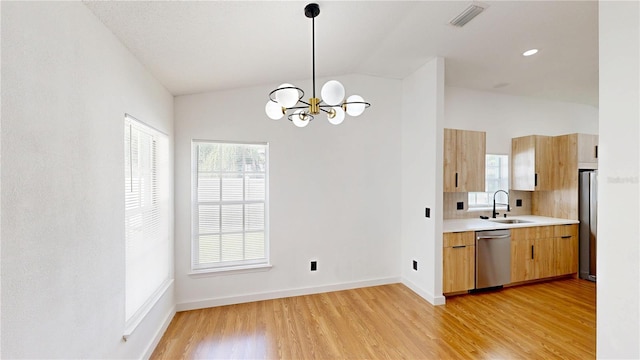 10747 Satinwood Cir, Orlando, FL 32825 - kitchen featuring stainless steel appliances, vaulted ceiling, a sink, light countertops, and a chandelier