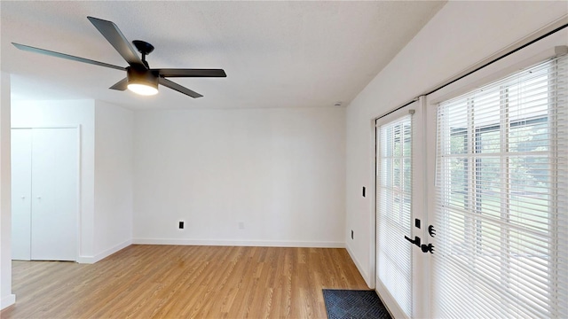 10747 Satinwood Cir, Orlando, FL 32825 - unfurnished room featuring light wood-style flooring, healthy amount of natural light, ceiling fan, and baseboards