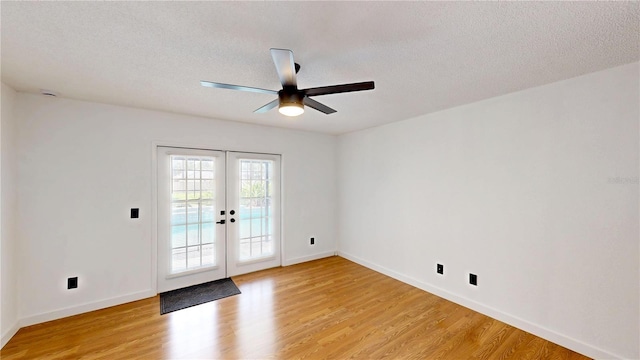 10747 Satinwood Cir, Orlando, FL 32825 - unfurnished room featuring french doors, ceiling fan, light wood-style flooring, baseboards, and a textured ceiling
