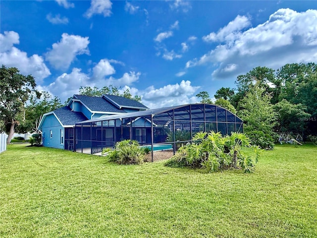 10747 Satinwood Cir, Orlando, FL 32825 - back of house with a lawn, an outdoor pool, roof with shingles, and a lanai