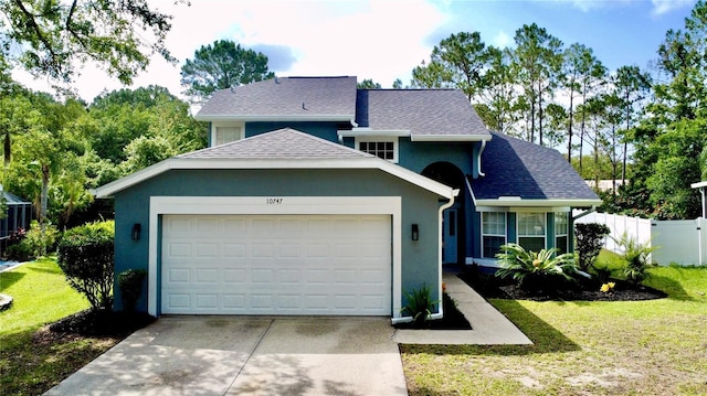 10747 Satinwood Cir, Orlando, FL 32825 - view of front of property featuring an attached garage, concrete driveway, stucco siding, and roof with shingles