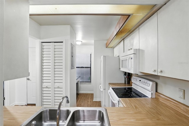 3012 S Semoran Blvd Unit S, Orlando, FL 32822 - kitchen with white appliances, light countertops, white cabinetry, and wood finished floors
