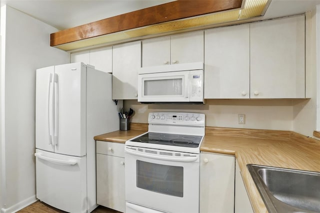 3012 S Semoran Blvd Unit S, Orlando, FL 32822 - kitchen with white appliances, light countertops, and white cabinetry
