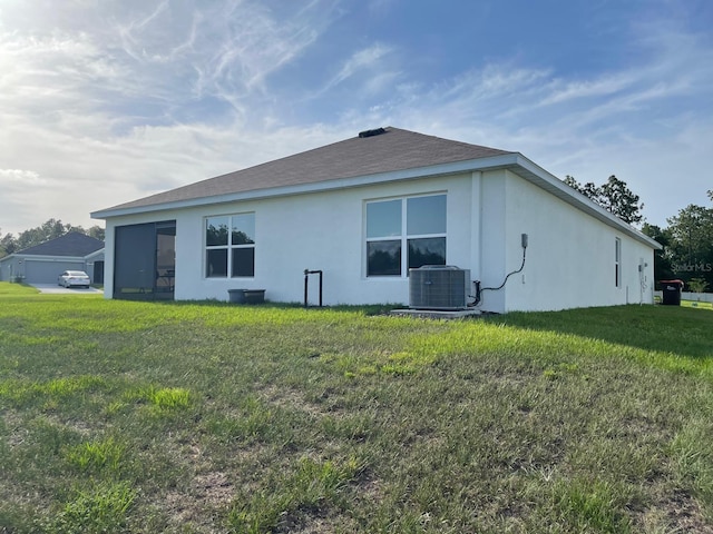 7172 SW 135th Pl, Ocala, FL 34473 - rear view of house with cooling unit, stucco siding, and a lawn