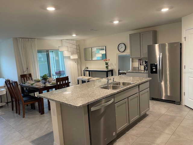 7172 SW 135th Pl, Ocala, FL 34473 - kitchen with stainless steel appliances, gray cabinetry, a center island with sink, light tile patterned floors, and recessed lighting