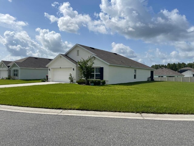 7172 SW 135th Pl, Ocala, FL 34473 - view of front of home featuring stucco siding, an attached garage, and concrete driveway