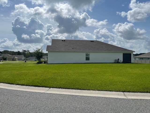 7172 SW 135th Pl, Ocala, FL 34473 - view of side of home with a yard and stucco siding