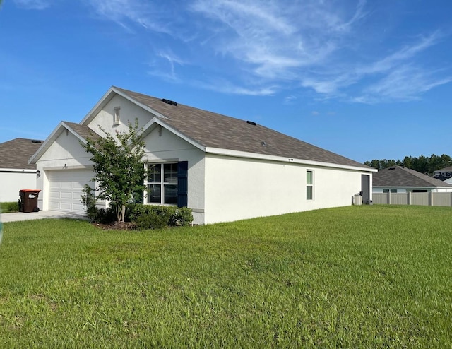 7172 SW 135th Pl, Ocala, FL 34473 - view of side of property with stucco siding, a lawn, and a garage