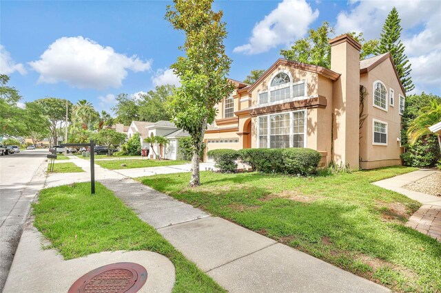 2971 Cayman Way, Orlando, FL 32812 - view of front of property with a front lawn, stucco siding, and an attached garage