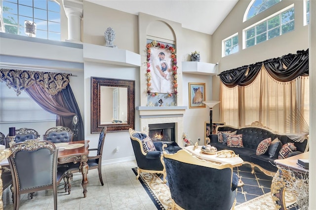 2971 Cayman Way, Orlando, FL 32812 - living room with high vaulted ceiling, a warm lit fireplace, and baseboards