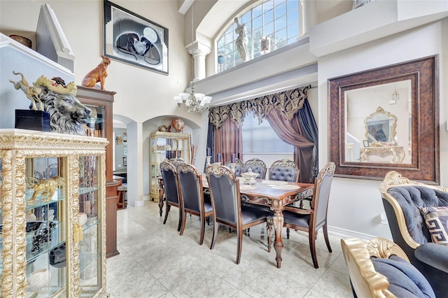 2971 Cayman Way, Orlando, FL 32812 - dining room with arched walkways, a high ceiling, and baseboards