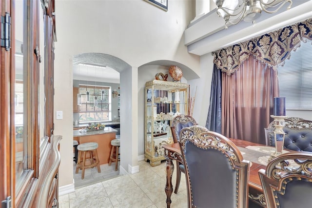 2971 Cayman Way, Orlando, FL 32812 - dining space with a chandelier, arched walkways, and light tile patterned floors