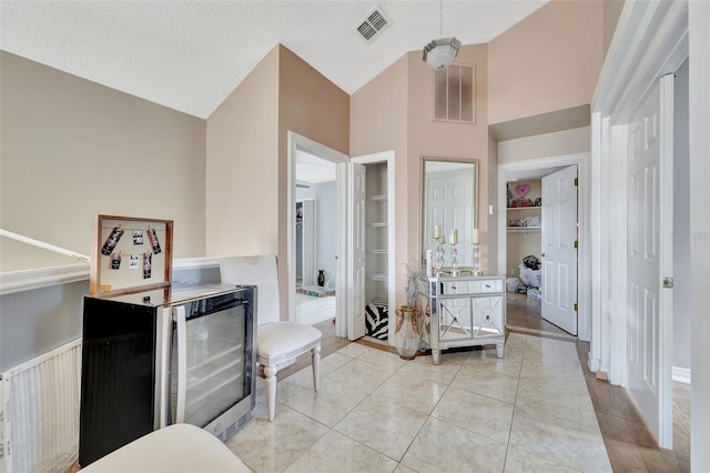 2971 Cayman Way, Orlando, FL 32812 - bathroom with high vaulted ceiling, a walk in closet, beverage cooler, built in shelves, and tile patterned flooring