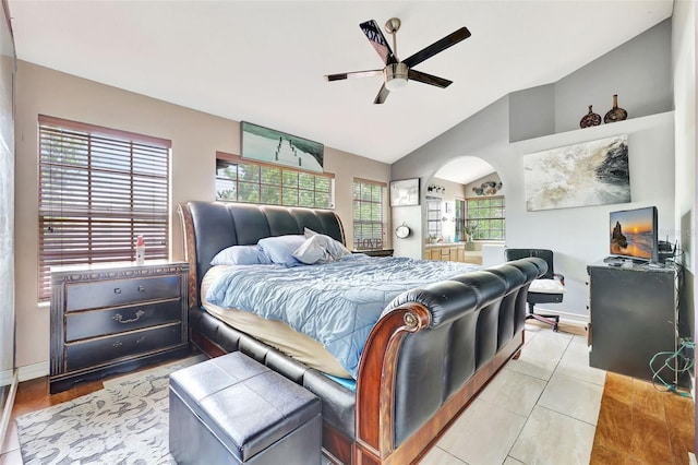2971 Cayman Way, Orlando, FL 32812 - bedroom with arched walkways, vaulted ceiling, light tile patterned floors, baseboards, and a ceiling fan