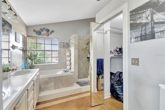 2971 Cayman Way, Orlando, FL 32812 - bathroom featuring tile patterned flooring, a garden tub, a walk in closet, double vanity, and lofted ceiling