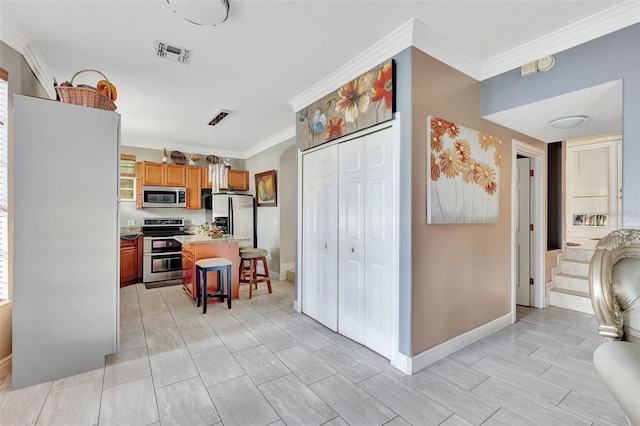 2971 Cayman Way, Orlando, FL 32812 - kitchen with appliances with stainless steel finishes, crown molding, a breakfast bar area, light countertops, and a center island