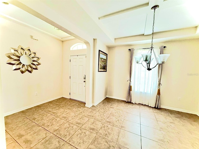 1016 Fountain Coin Loop, Orlando, FL 32828 - entrance foyer with a chandelier, light tile patterned floors, a raised ceiling, and arched walkways