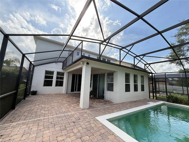 1016 Fountain Coin Loop, Orlando, FL 32828 - rear view of house featuring a patio area, glass enclosure, and stucco siding