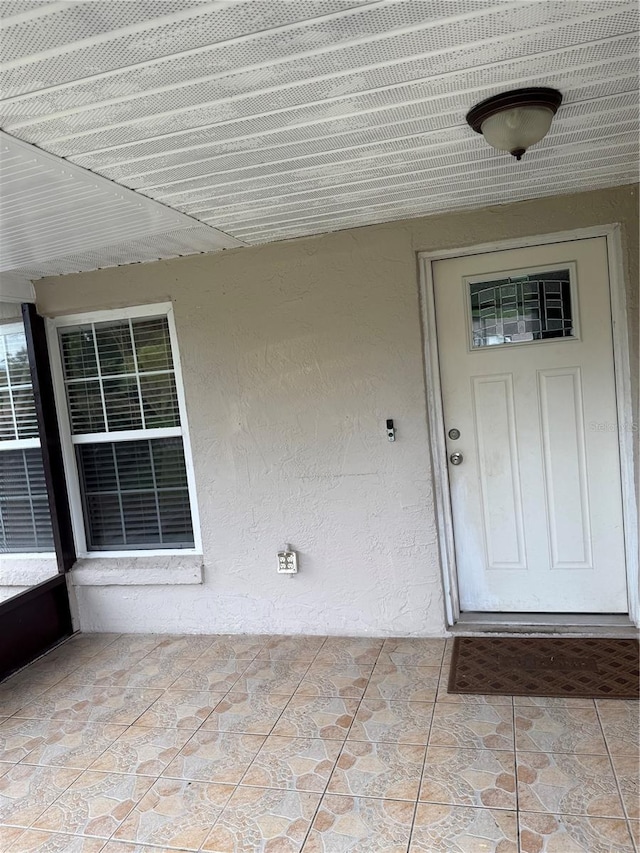 7104 Blue Earth Ct, Orlando, FL 32818 - doorway to property with stucco siding