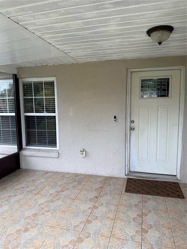 7104 Blue Earth Ct, Orlando, FL 32818 - doorway to property with stucco siding
