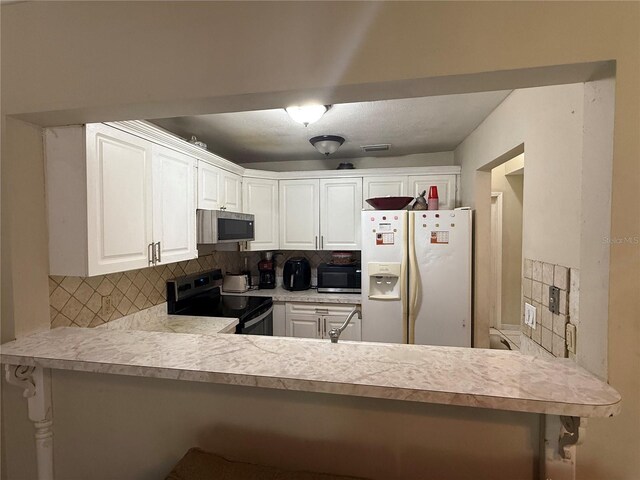 7104 Blue Earth Ct, Orlando, FL 32818 - kitchen featuring white refrigerator with ice dispenser, black electric range oven, stainless steel microwave, and decorative backsplash