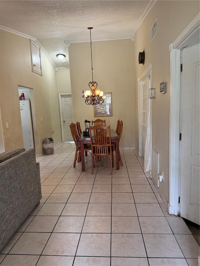 7104 Blue Earth Ct, Orlando, FL 32818 - dining area featuring ornamental molding, light tile patterned flooring, a chandelier, and a textured ceiling
