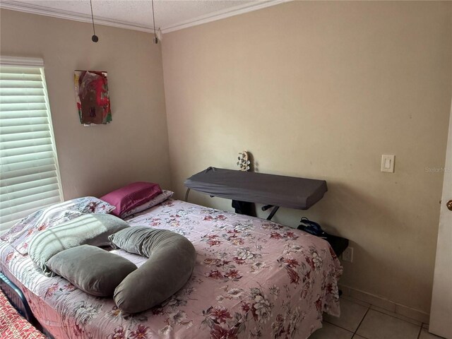 7104 Blue Earth Ct, Orlando, FL 32818 - tiled bedroom with crown molding, a textured ceiling, and baseboards