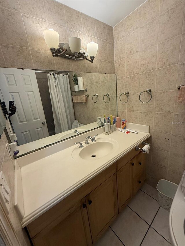 7104 Blue Earth Ct, Orlando, FL 32818 - bathroom featuring tile walls, tile patterned flooring, vanity, and a shower with curtain