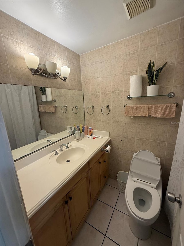 7104 Blue Earth Ct, Orlando, FL 32818 - bathroom featuring tile walls, tile patterned flooring, toilet, and vanity