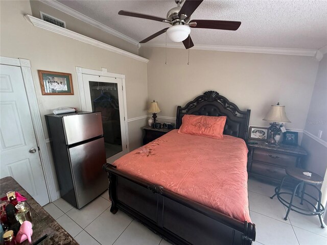 7104 Blue Earth Ct, Orlando, FL 32818 - bedroom with freestanding refrigerator, crown molding, light tile patterned floors, a textured ceiling, and ceiling fan