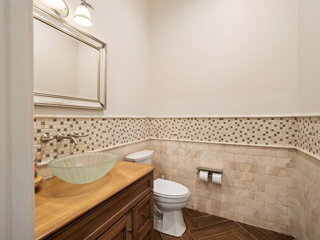 11106 Coniston Way, Windermere, FL 34786 - half bathroom with vanity, tile walls, wainscoting, and toilet
