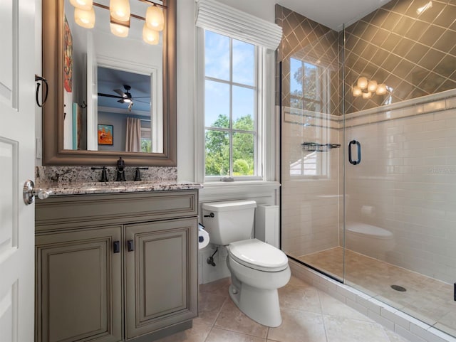 11106 Coniston Way, Windermere, FL 34786 - bathroom with toilet, tile patterned flooring, a stall shower, vanity, and a ceiling fan