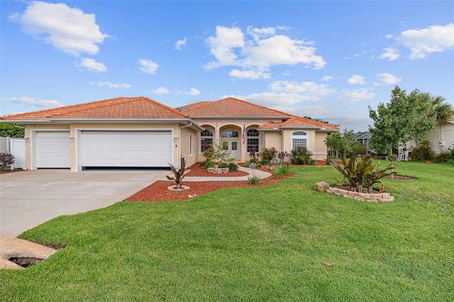 5 Florence Ct, Palm Coast, FL 32137 - mediterranean / spanish-style home featuring a garage, concrete driveway, a tiled roof, a front yard, and stucco siding