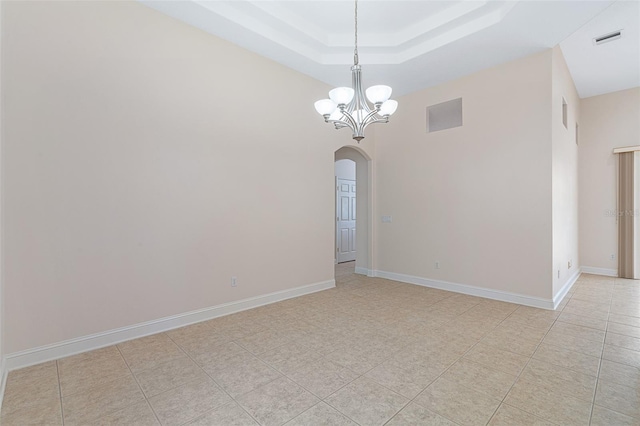 5 Florence Ct, Palm Coast, FL 32137 - unfurnished room featuring arched walkways, a chandelier, a tray ceiling, a towering ceiling, and light tile patterned floors